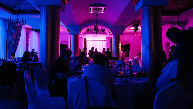 Party in neon light in the hall of the restaurant