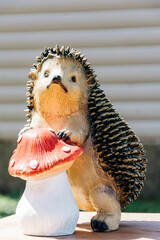 Sculpture of a hedgehog with a mushroom in nature