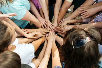 Many female hands are woven together in a team game