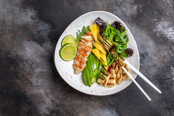 Buddha bowl, Grilled chicken breast, halloumi, pineapple, avocado, green rocket salad, lime and olive oil. healthy and balanced food. banner, menu recipe place for text, top view