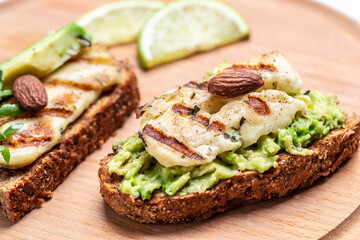 Bruschetta, toasted grilled Halloumi cheese and slices of avocado guacamole. top view with space for text. Healthy food
