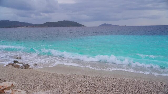 Pebble beach and clear azure sea water in the city of Kash Turkey. Tourist destination - Kash, Turkey