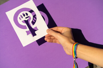 A woman holding a drawing in a vindication in favor of equality between men and women, purple...