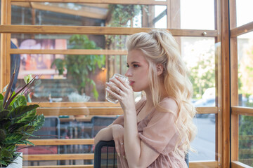 Portrait of attractive young woman drinking coffee