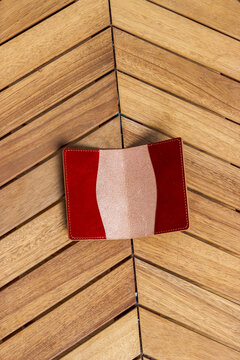 Passport cover made of genuine leather on a wooden background