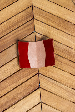 Passport cover made of genuine leather on a wooden background