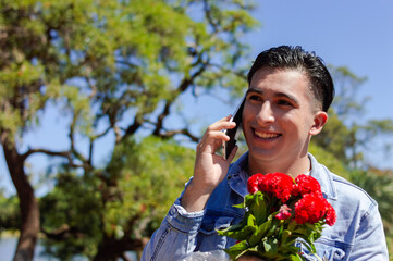 Obraz premium caucasian young man using phone communication without limits for valentine's day.