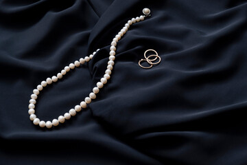 Pearl necklace on black silk.