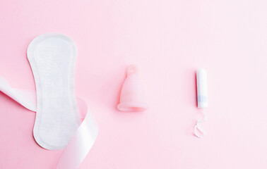 Obraz premium Menstrual cup, tampon, woman cup for sanitary protection. Pink ribbon with menstrual cup. Menstruation feminine period. Zero waste concept, ecofriendly lifestyle, reduced banner consumption.