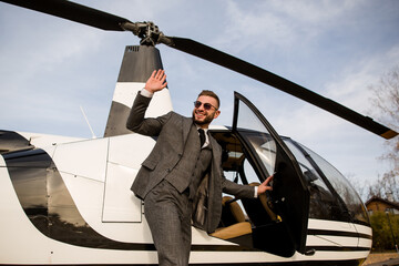 Rich man says goodbye to business partners as he boards a private helicopter