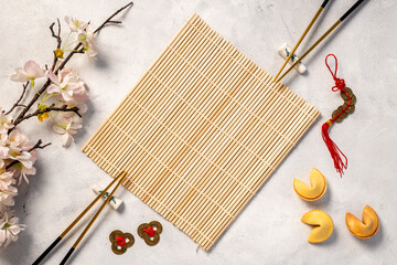 Chinese New Year tabble setting with fortune cookies and golden chopsticks