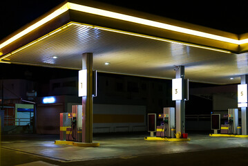 Car filling station at night.