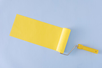 Yellow painted banner with paint roller and copyspace