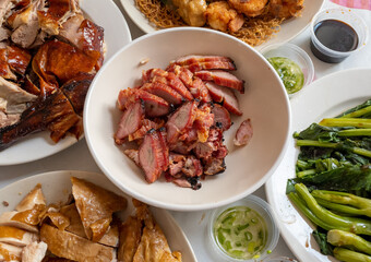 Top view of a dining table with a spread of meat and vegetable dishes for a holiday feast.