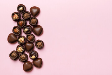 Different kinds of chocolates on colored table close-up. Top View and Flat Lay with copy space