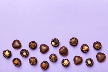 Different kinds of chocolates on colored table close-up. Top View and Flat Lay with copy space