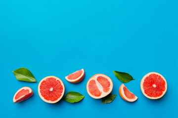 fresh Fruit grapefruit with Juicy grapefruit slices on colored background. Top view. Copy Space. creative summer concept. Half of citrus in minimal flat lay with copy space