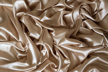 Beautiful elegant wavy beige or light brown satin silk fabric, abstract background design. Copy space. Card or banner