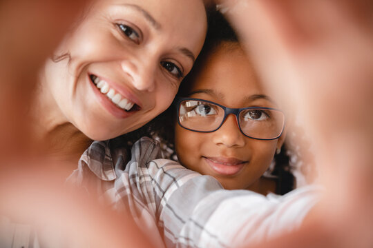 African Smiling Happy Mother Mom And Little Preteen Girl Daughter Taking Making Selfie Photo Together For Social Media Online. Closeup Portrait Of Family. Motherhood Concept