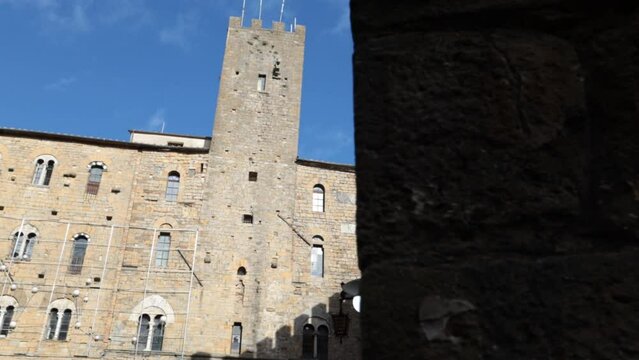 The facade of the beautiful medieval building, the Palazzo Pretorio stands in the Piazza dei Priori in the ancient city of Volterra in Tuscany, Italy.