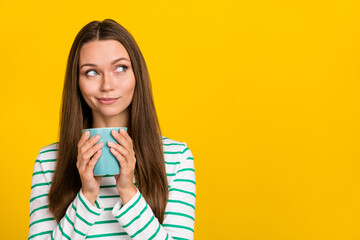 Photo of dreamy cute young woman wear striped shirt drinking looking empty space isolated yellow color background - obrazy, fototapety, plakaty
