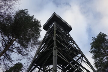 Fototapeta na wymiar Looking up the steel framework of Friedrich Kabus Turm lookout tower under a dramatic and stormy winter sky, low angle view (horizontal), Bad Salzdetfurth, Lower Saxony, Germany