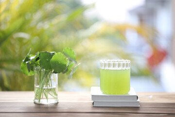 pennywort juice and notebook on wooden table