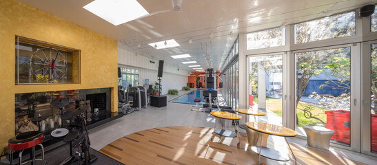 Modern interior of luxury private house. Musical equipment. Pool.