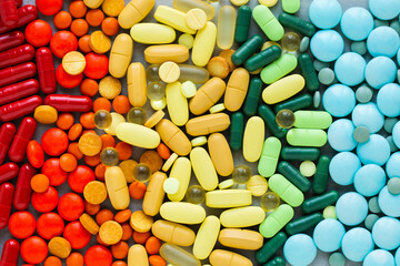 Assorted rainbow colorful tablets, pills, drugs background. Medication and healthcare concept. Close up, top view