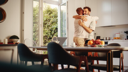 Gentle Scenes of a Stylish Young Adult Gay Couple Hug at Home. Two Happy Men in Love Having Fun in Casual Clothes in Kitchen Area. Cute LGBTQ Relationship Content.
