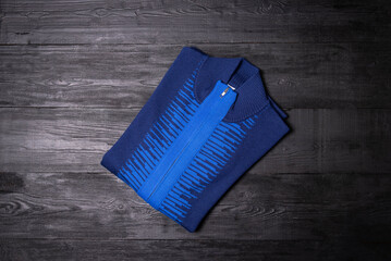 blue men's sweater on a black background
