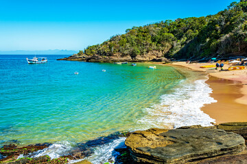 Paradise beach with colorful transparent waters surrounded by stones and vegetation in the city of Buzios, one of the main tourist destinations in Rio de Janeiro