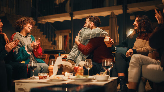 Big Garden Birthday Party Celebration with Beautiful People on a Warm Summer Evening. Close International Friends Gift a Present to a Friend, Hug. Everybody Cheering, Laughing, Smiling and Having Fun.