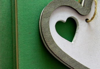 Wooden heart on green books. Love valentine concept