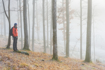 Fototapeta premium Man standing in misty forest