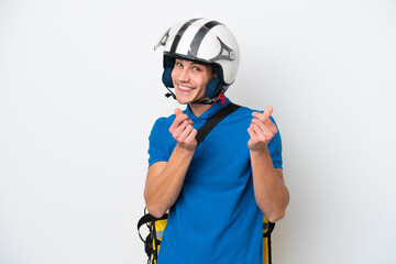 Young caucasian man with thermal backpack isolated on white background making money gesture