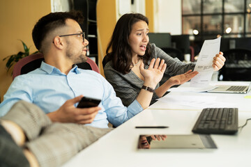 Colleagues arguing in office. Angry businesswoman yelling at her collegue