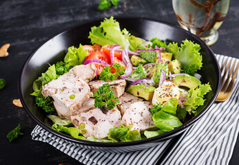 Trendy salad. Chicken meatloaf with salad fresh tomatoes, red onin and avocado. Healthy food, ketogenic diet. Keto diet.