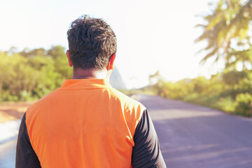 view of a man walking on the road