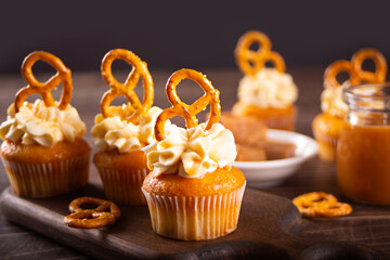 Homemade cupcakes with caramel syrup and whipped cream cheese