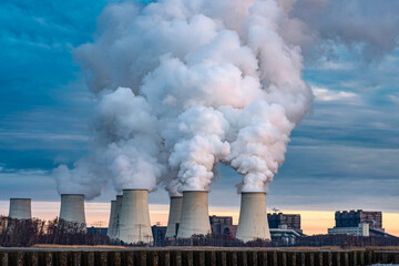 Smoking pipes of thermal power plant on sunset.