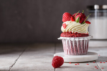 red velvet cupcake with raspberries and cream