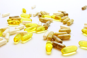 fish oil capsules and tablets scattered on the table on a light background macro, dietary supplements, omega 3, fish fat