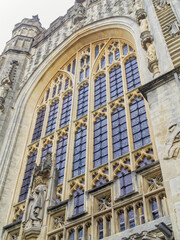 Front facade of Bath Abbey feature stained glass window and stonework mullions and details