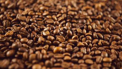 Texture of freshly coffee beans. Lots of roasted beans for preparation of fragrant drink. Close up.