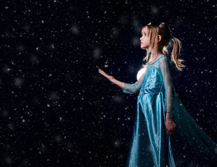 Young girl snow princess. Mystery fantasy girl in blue lush dress. Art background winter frozen and...