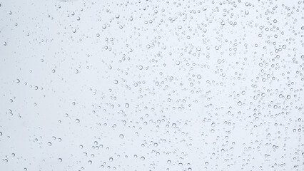 Water drops on glass on snow background