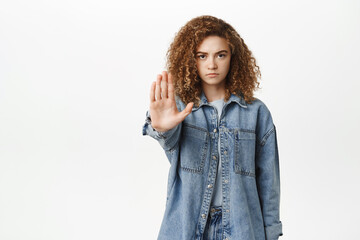 Stop, taboo concept. Young serious woman showing no, prohibit, rejection gesture, forbid smth bad,...