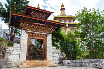 Fototapeta premium Entrance gate and exterior of the Khamsum Yeulley Namgyal chorten temple in Punakha, Bhutan, Asia
