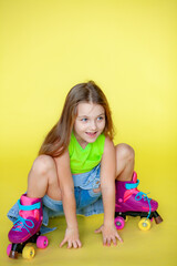 Funny little blonde girls 6 years old in everyday bright clothes posing isolated on a yellow studio...